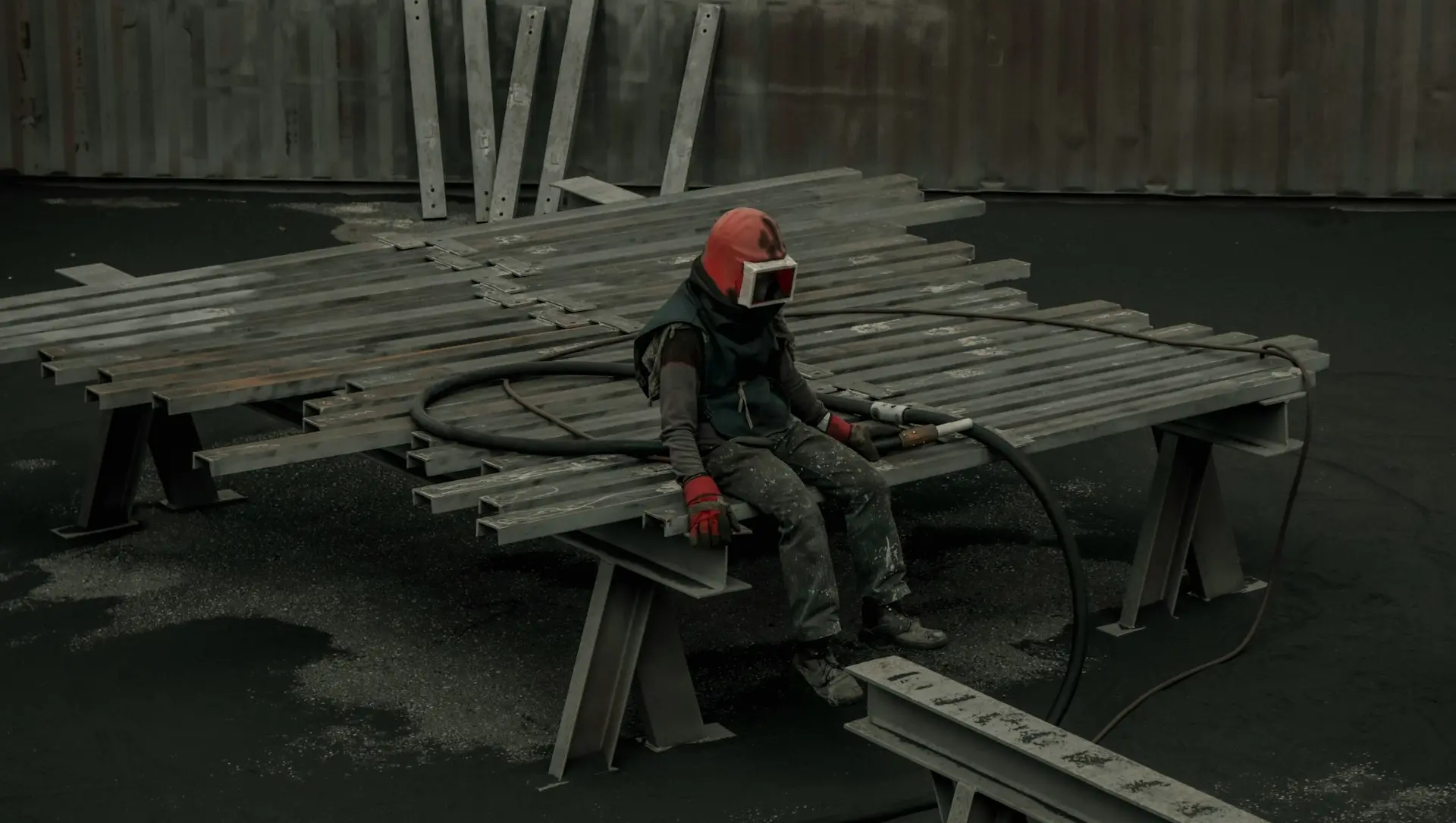 man in black jacket and red helmet sitting on brown wooden bench